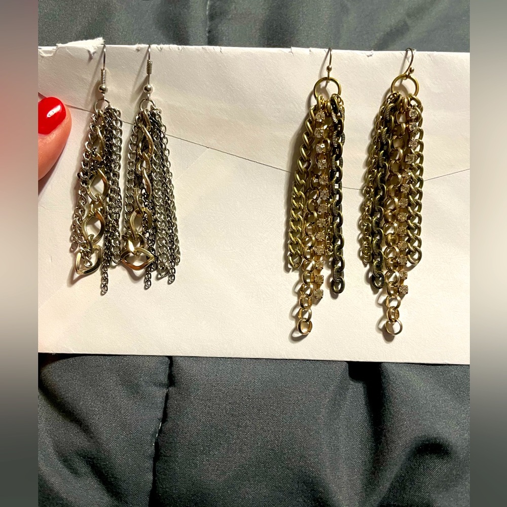 Two pairs of earrings.   One silver. One gold.